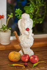 sculpture of an angel , flowers and fruits