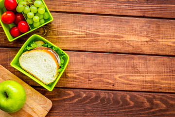 healthy food in lunchbox for dinner at school wooden table background top view mockup