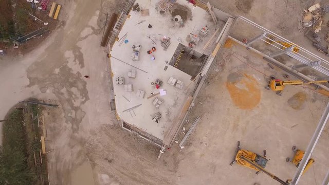 foreman construction worker on a industrial building industry construction site 4 K 50 fps aerial  footage from above with flying drone