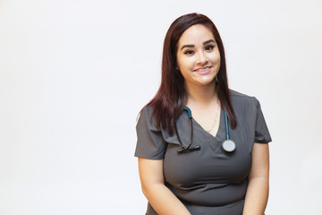 Young female healthcare professional, woman nurse on white background with copy space