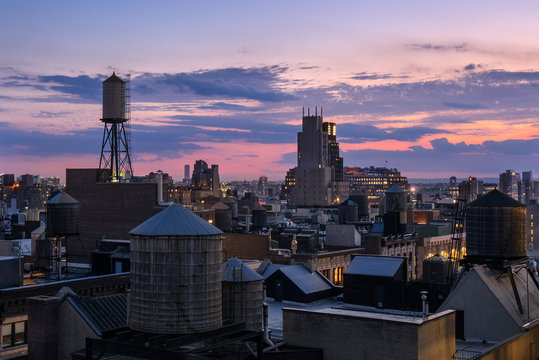 Chelsea rooftops at twilight with water towers. Manhattan, New York City
