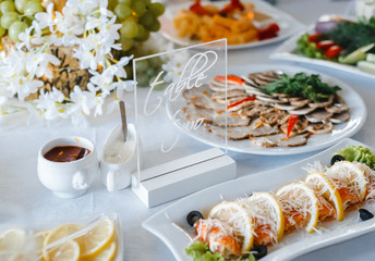 table setting with light fish and meat snacks