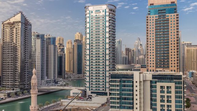 Dubai Marina skyscrapers and Marina promenade aerial timelapse. Modern towers and boats from above, port with luxury yachts. United Arab Emirates