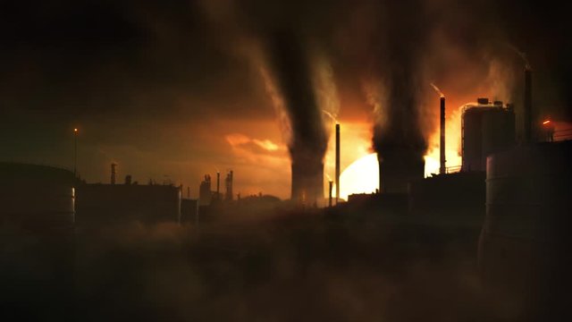 scenic wide concept animation shot of heavy industry causing climate change and pollution. bright golden sunset and dark dystopic black smoke  clouds, silhouettes of chimneys and industrial buildings