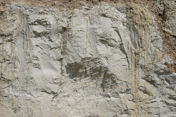Texture of different layers of clay underground in a clay quarry. clay wall background close up