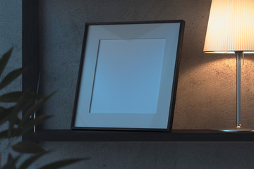 Blank photo frame on wooden shelf in stylish modern dark living room. 3d rendering. Evening