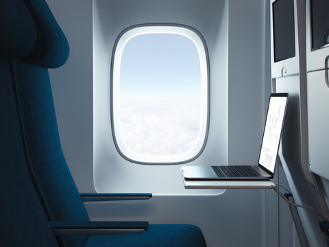 Modern laptop in airplane interior with window on background. 3d rendering.