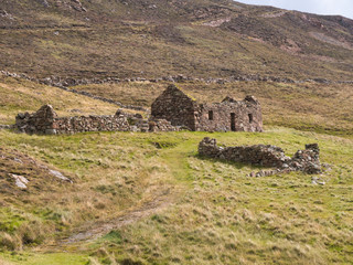 An abandoned, derelict farmhouse and out buildings near North Ham on Muckle Roe, Shetland, UK © Alan