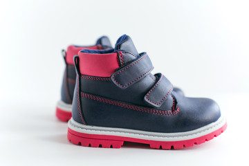 isolated dark blue with pink children s spring and autumn leather shoes on a white background 