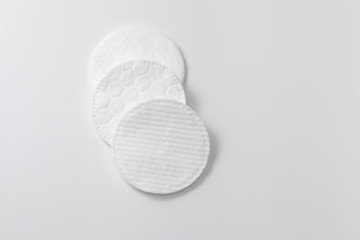Cotton pads for removing cosmetics on a gray plain background