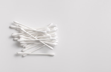 A pile of cotton swabs on a gray background. Space for text