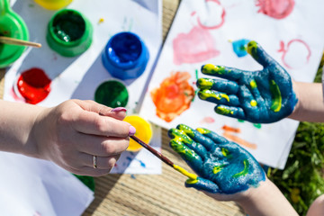 Summer. Open space.  Hands painted with colored paint. Body paint.