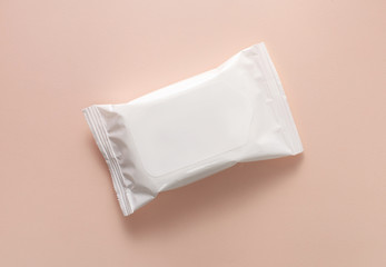 Packing a white pack of wet wipes on a pink background