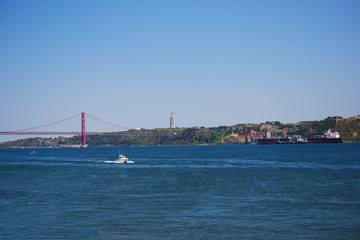 Naklejka premium sea ships sky Portugal bridge