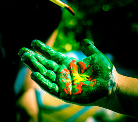 Summer. Open space.  Hands painted with colored paint. Body paint.