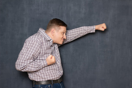 Funny awkward man is posing like brave flying superhero - Powered by Adobe