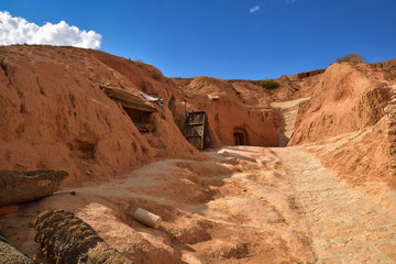 Fototapeta na wymiar troglodyte dwelling, cave dug in the ground on a mountain slope