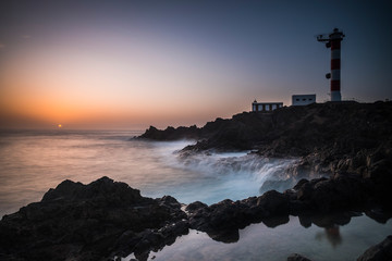 Beautiful sea ocean landscape with big powered waves on the rocks during sunset with classic...