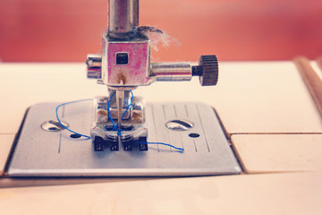 Sewing machine, closeup needle and presser foot with holder.
