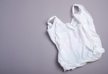 Clear disposable plastic bag on gray background. Space for text