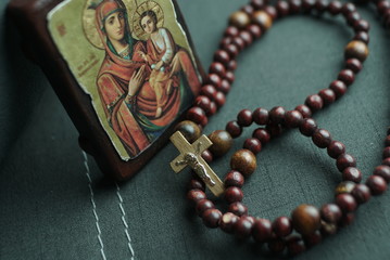 wooden rosary and icon of the Virgin Mary with the little Jesus