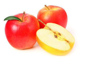 red apples with slices and green leaves isolated on a white background