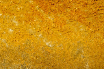 bright yellow sulfur wall texture ,  brimstone colored background , old rough ginger stone