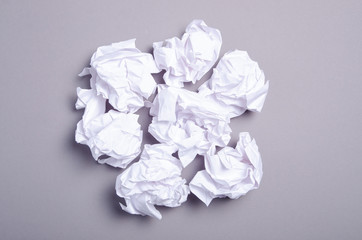 Crumpled paper ball on gray background, top view