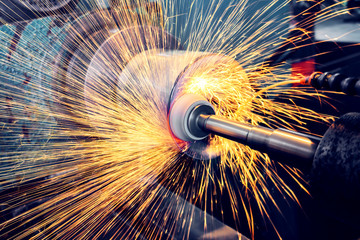 Grinding a cylindrical part on a circular grinding machine, high-precision abrasive grinding with sparks. - obrazy, fototapety, plakaty