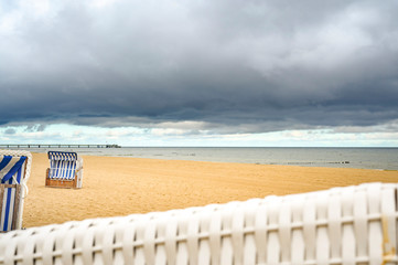 View over a beach chair on a lonely beach on Usedom overlooking the sea to dramatic looking storm...