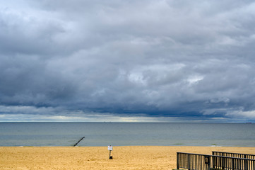 Lonely beach on Usedom with view over the sea to dramatic looking storm clouds.