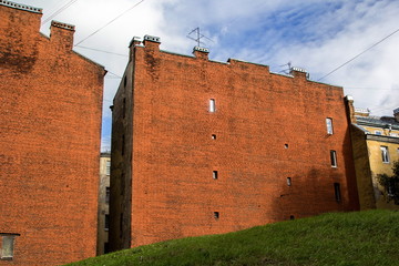 The facade of a brick house looks like a fortress.