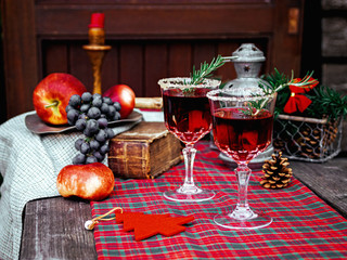 Christmas still life , two glass with red raspberry beverage decorated with rosemary , vintage old fashion style.
