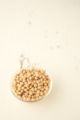 Soybeans are in a cup, placed on a wooden table with copy space,Dry bean yellow  color