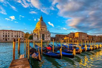 Sunrise view of Canal Grande with Venice gondola and Basilica di Santa Maria della Salute in...