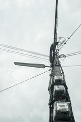 Electricity poles and electrical lines in a village in Thailand