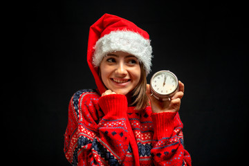 Fototapeta premium girl in Christmas dress with clock in her hand