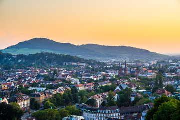 Germany, Aerial view over black forest city freiburg im breisgau from above at sunset in romantic orange dawning twilight mood