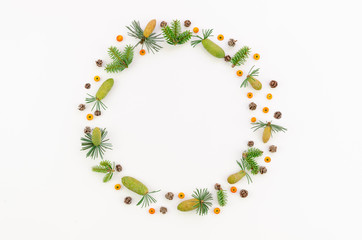 Festive wreath of grape vines with fur branches, rowanberries and cones. Christmas DIY frame. New Year round wreath on white background. Flat lay mockup