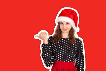 portrait of woman in dress pointing left with thumb and upset. emotional girl in santa claus christmas hat Magazine collage style with trendy color background. holiday concept