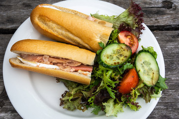 Fish and cheese sandwich with salad