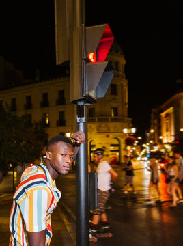 Portrait of cool young man on a steet at night in the city