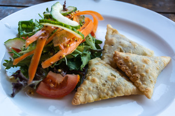 Lamb puffs with salad.