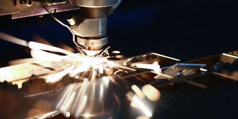 Laser metall cut cnc machine. Fly fire sparks background. Industrial processing concept
