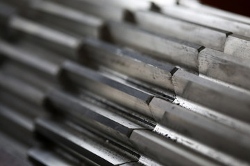 Closeup of metal cogwheel on dark background as part of full machine and steampunk concept