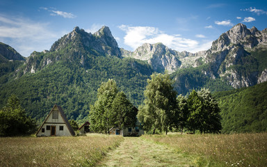 Beautiful mountain villages with blooming meadows and mountain peaks