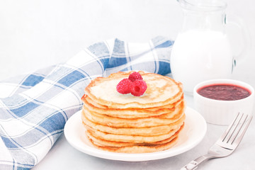Classic american pancakes with raspberries jam
