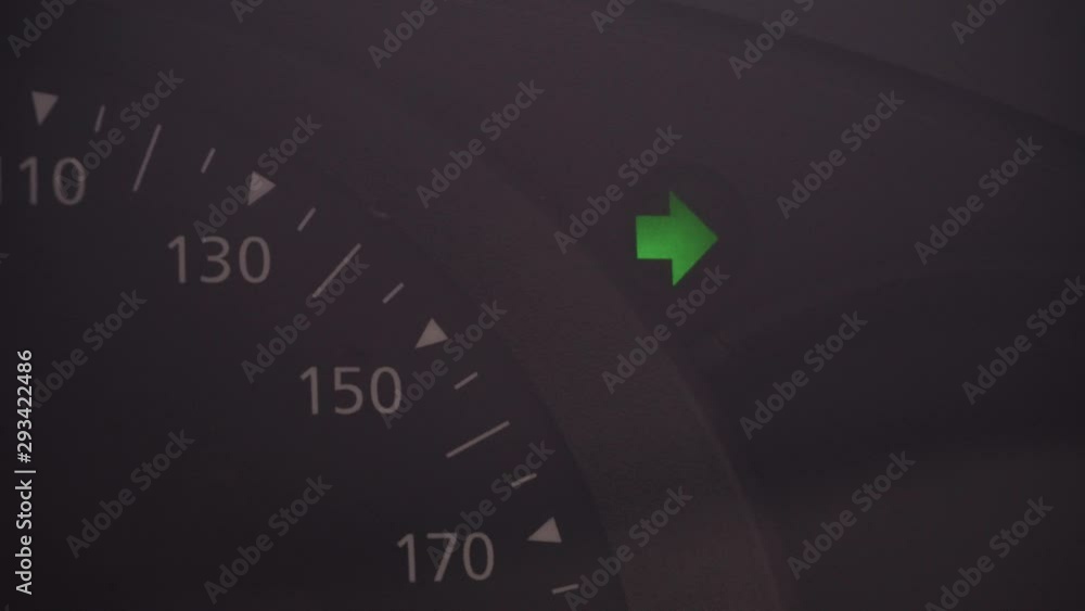 Poster the right arrow of the turn signal of the car on the dashboard. flashing turn signal