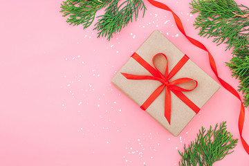 Isolated present or gift box in craft paper with red ribbon bow