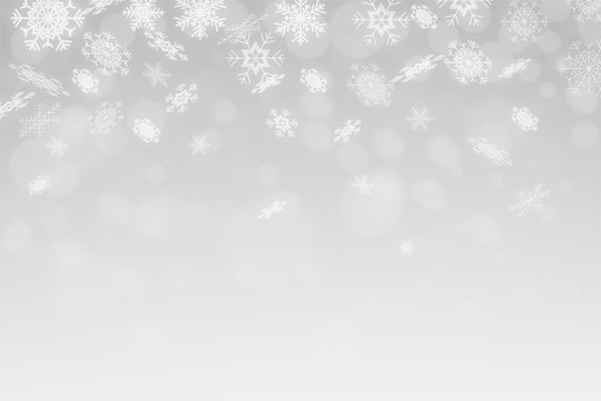 Snowflakes and snowfall on a cold blue winter background christmas
